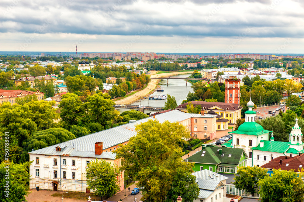 A panoramic view from above to the city of Vologda and the river of the same name, Oktyabrsky and pedestrian red bridges over the river.