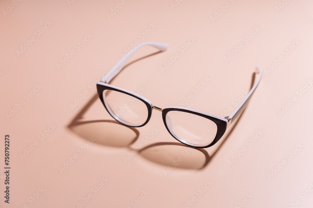 Vision glasses with black frames on a pink background. Vision glasses with black frames on a pink background.