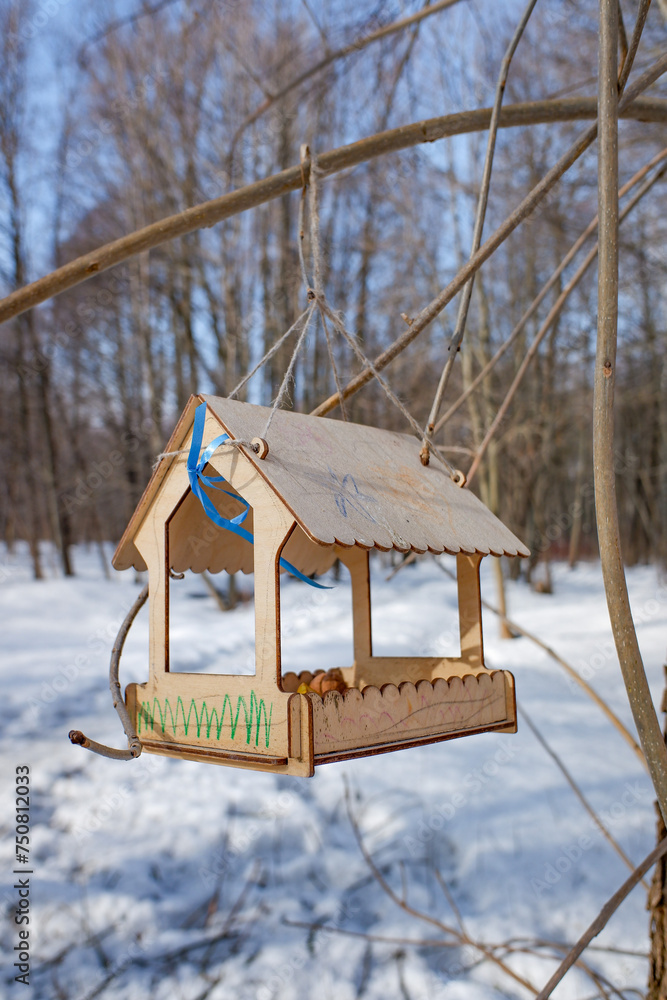 Wooden bird feeder on tree branches. Winter landscape. Wooden bird feeder on tree branches. Winter landscape.