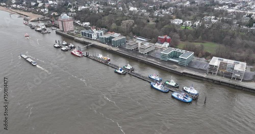 Hamburg, tugboats are moored at the pier, Neue Schlepperbrucke. Shipping and maritime activities. Assist with mooring and unmooring and shifting vessels. Aerial drone view. photo