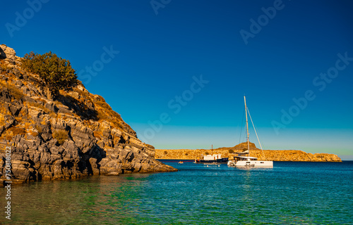 Yachts are moored in the bay.