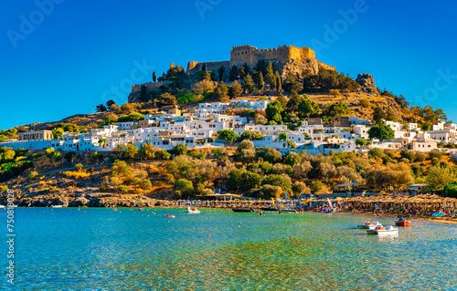 View of the Acropolis of Lindos and the city from the beach. photo