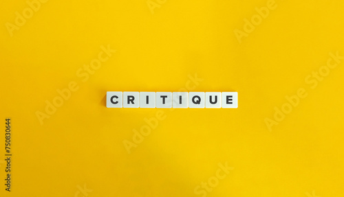 Critique Word. Text on Block Letter Tiles on Flat Background. Minimalist Aesthetics. photo