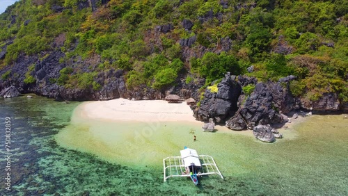 Aerial view 4k drone shot of small islands and beaches around Calauit National park Coron island, the Philippines. Crystal clear turquoise blue waters, palm tree lined white sandy beaches, and visible photo