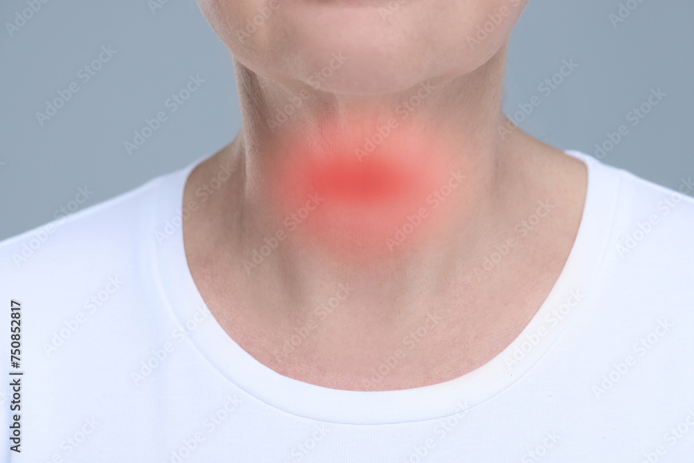 Endocrine system. Woman suffering from pain in thyroid gland on grey background, closeup - obrazy, fototapety, plakaty 