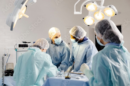 A group of doctors wearing masks are standing together around a table
