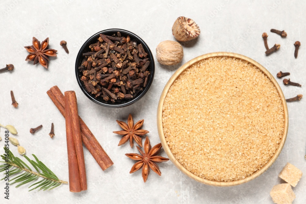 Different spices in bowls, nuts and fir branch on light gray textured table, flat lay Different spices in bowls, nuts and fir branch on light gray textured table, flat lay