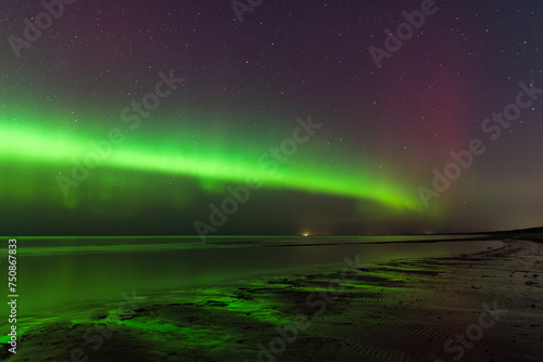 Aurora Borealis northen lights on the Baltic Sea beach in Latvia at March