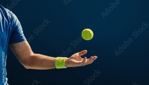 Tennis player catching a mid air ball on the court photo