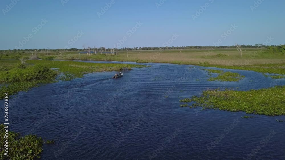 Boat sailing on a tropical flooded river in Pantanal. Aerial dolly out Boat sailing on a tropical flooded river in Pantanal. Aerial dolly out