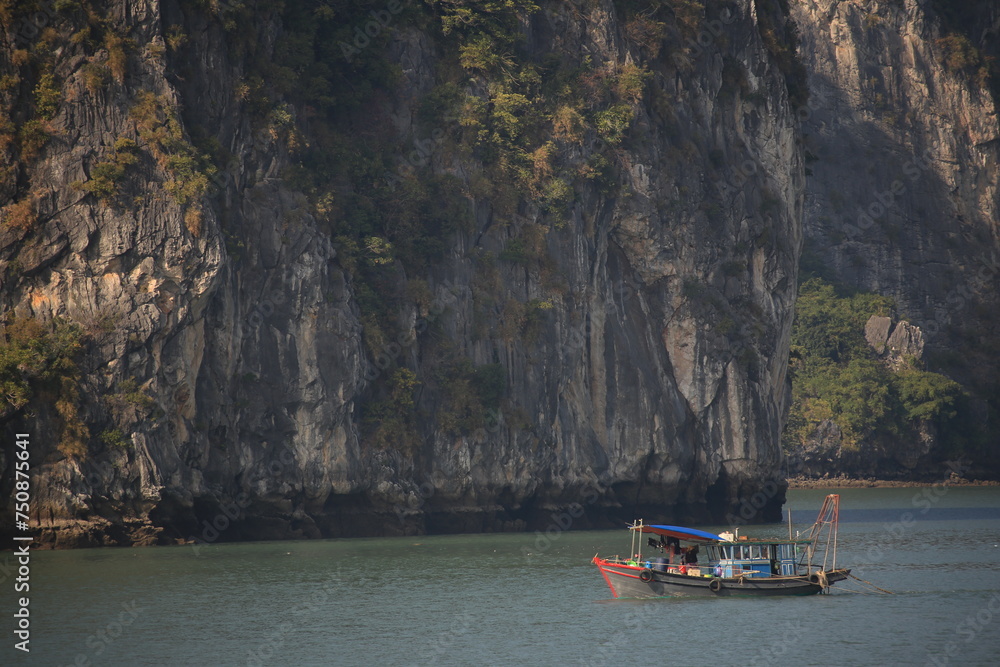 a vietnamese fishing boat in halong bay
