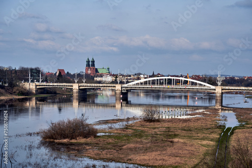 flooded meadow and road bridge over the Warta River in the city of Poznan © GKor