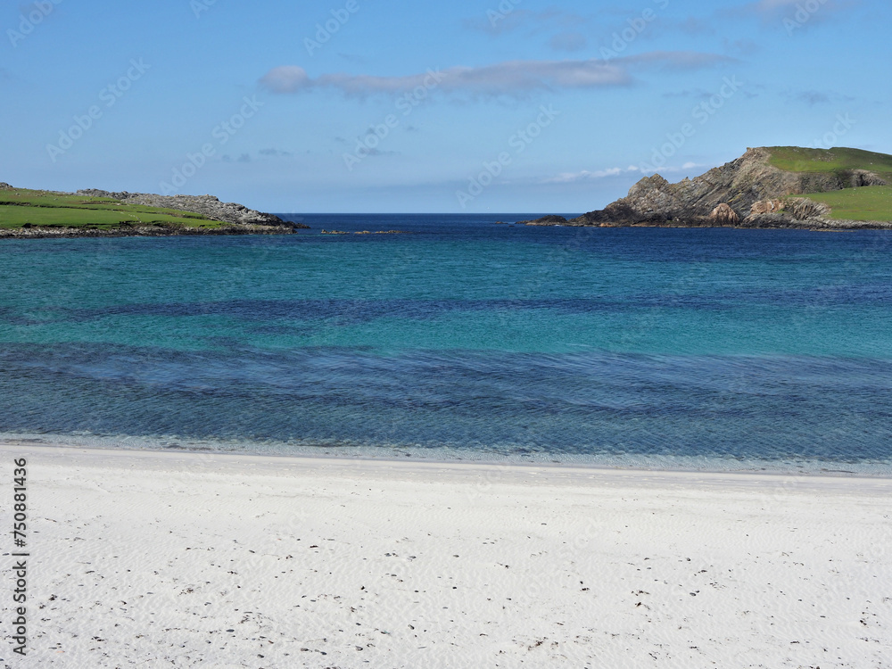Minn beach, or Bannaminn beach, a stunning tombolo in the Shetland islands. Blue sky, turquoise water and white sand. Shetland Islands. Scotland