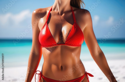  a beautiful female body from neck to legs in a red bikini, swimsuit against the backdrop of a sandy beach and the sea, ocean.