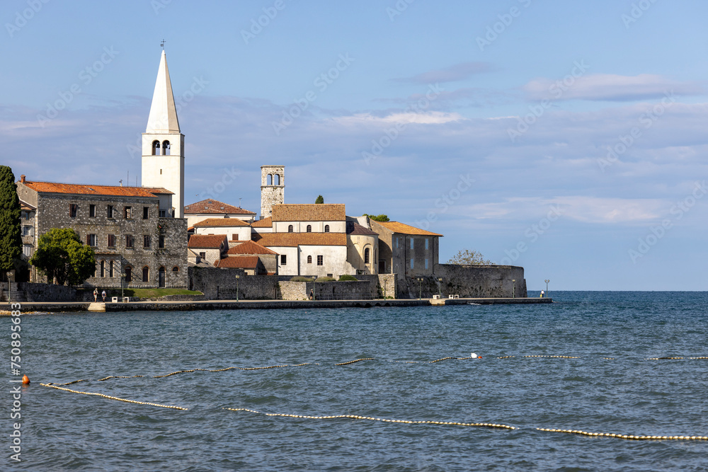 View from Nikole Tesle street of seaside with bell tower of Euphrasian Basilica, Porec, Croatia, Istria