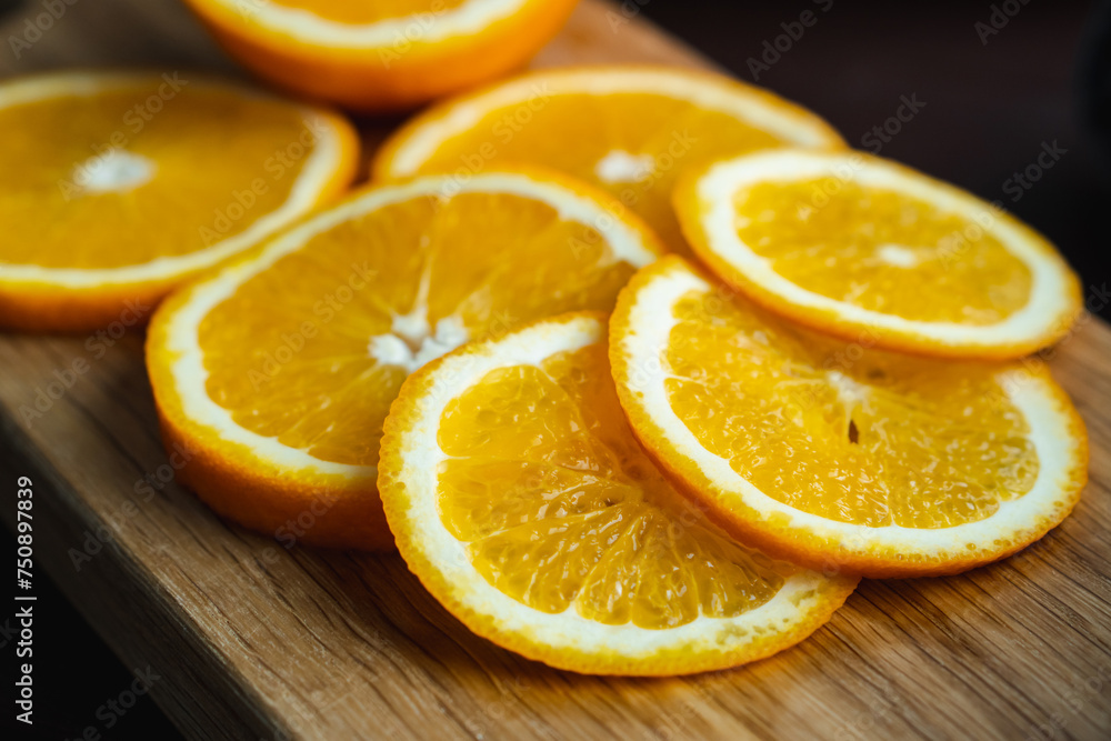 Sliced oranges fruit near denim textile on wooden board. Orange juicy fruit, citrus minimal concept Sliced oranges fruit near denim textile on wooden board. Orange juicy fruit, citrus minimal concept