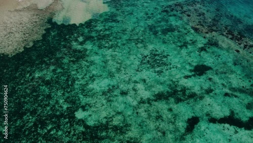 Aerial view 4k drone shot of small islands and beaches around Calauit National park Coron island, the Philippines. Crystal clear turquoise blue waters, palm tree lined white sandy beaches, and visible photo