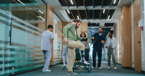 Multiethnic group of cheerful professional doctors and nurses dancing with happy patient in wheelchair. Team of medical staff and young man walking smiling and having fun in hospital.