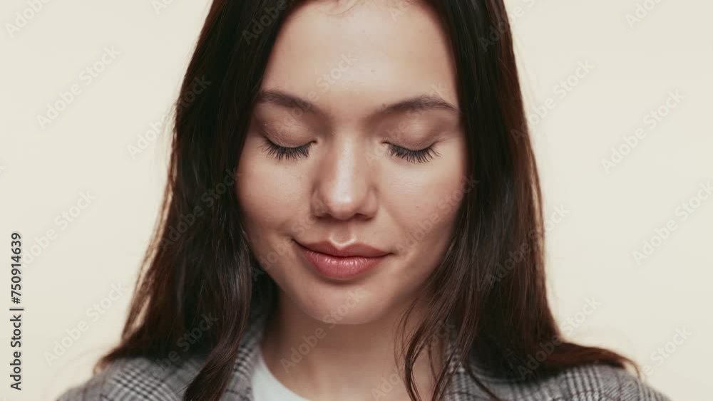 An attractive young woman giving a subtle, flirtatious glance to the camera with a warm, approachable smile. An attractive young woman giving a subtle, flirtatious glance to the camera with a warm, approachable smile.