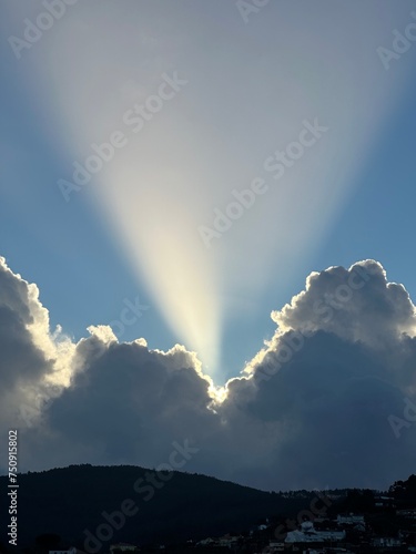 Ray of light over the storm clouds and the mountains, Eiras, O Rosal, Galicia, Spain, December 2022 photo