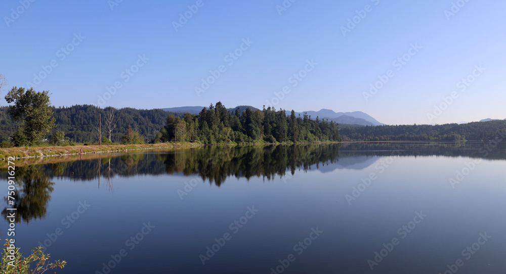 Mirror image of trees in the surface of lake
