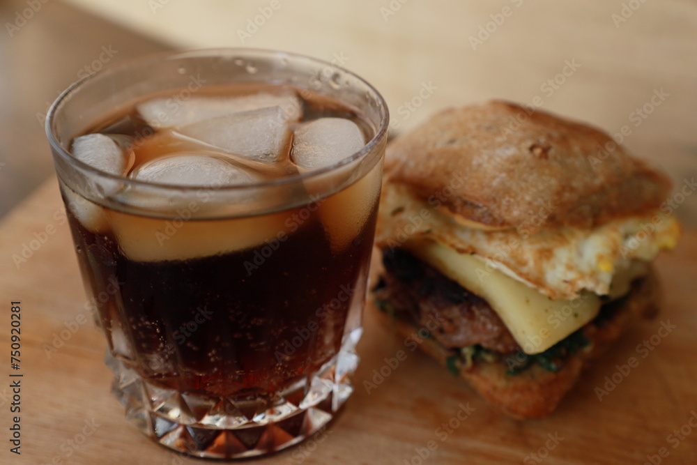 rustic burger and glass of coke rustic burger and glass of coke