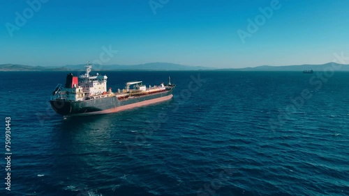 Petrochemical oil product cargo ship carrier at anchorage in sea waiting loading on industrial terminal. Aerial view photo