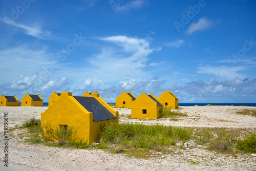 Ochre yellow stone slave huts in Bonaire island.