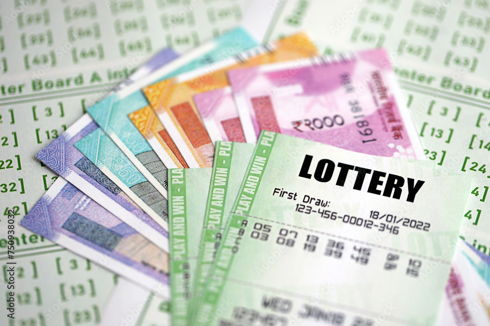 Green lottery tickets and indian rupees money bills on blank with numbers for playing lottery close up Green lottery tickets and indian rupees money bills on blank with numbers for playing lottery close up