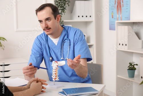 Male doctor explaining spin...