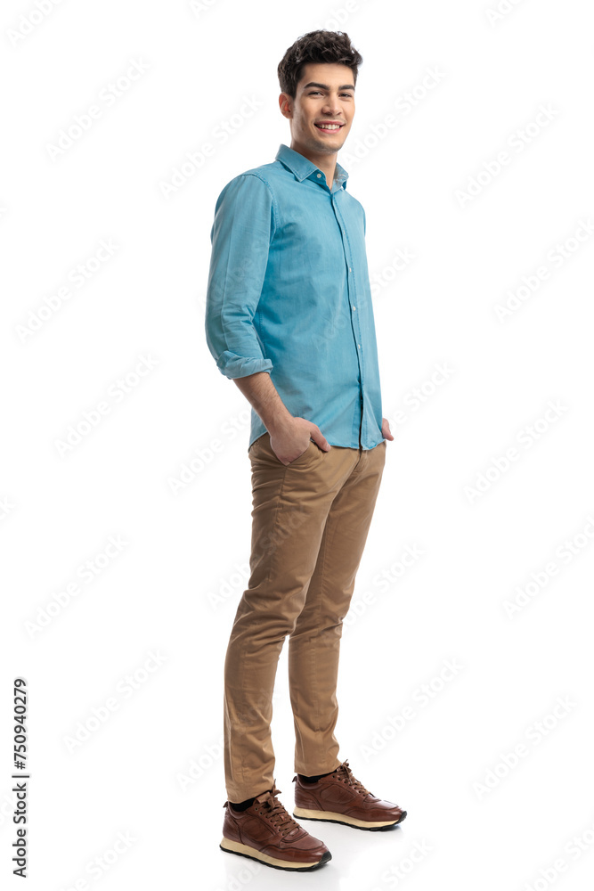 side view of relaxed casual man holding pockets side view of relaxed casual man holding pockets