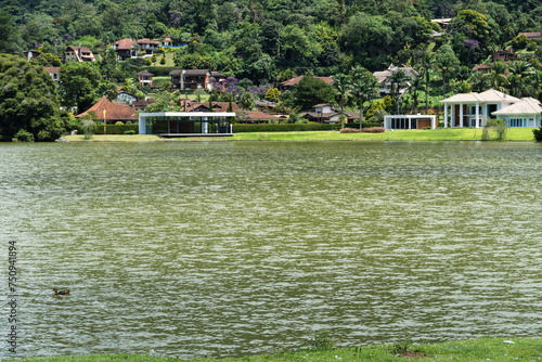 Lake Comary in Teresópolis, Rio de Janeiro, Brazil. Mountain region of the state. Place full of nature, with houses and hills around. Many geese and birds inhabit the region photo