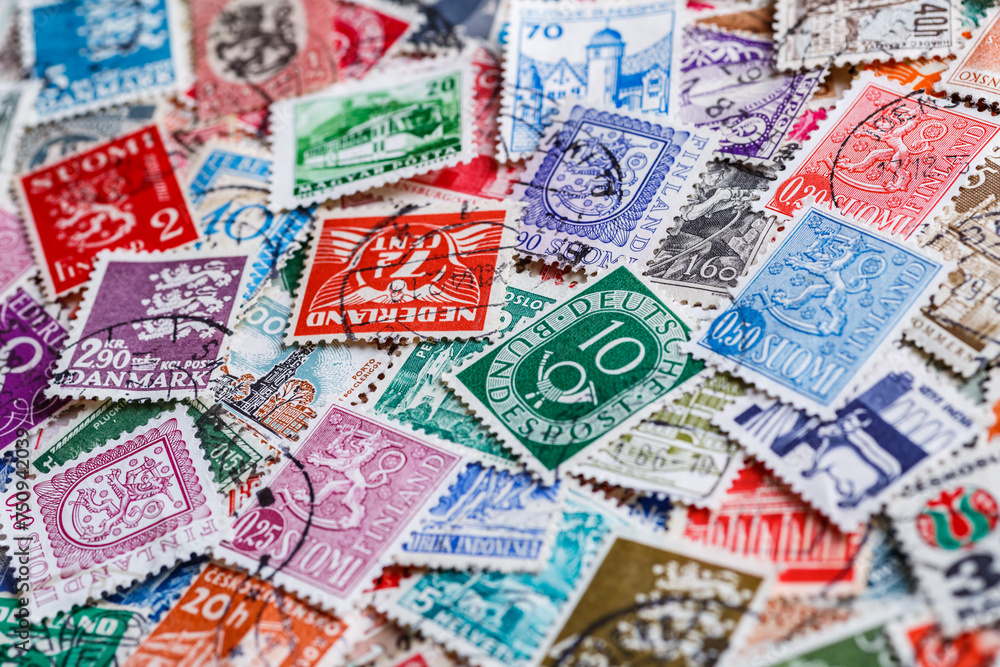 Postage stamps.A collection of world stamps in a pile.Postage stamps from different countries and times