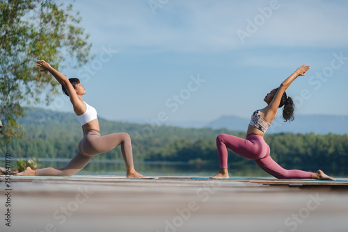 Beautiful attractive Asian woman practice fitness yoga pose on the pool above the Mountain peak in front of nature lake views, Feel so comfortable lifestyle and relax exercise in holiday morning