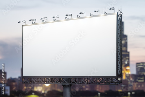 Blank white billboard on cityscape background at evening, perspective view. Mock up, advertising concept
