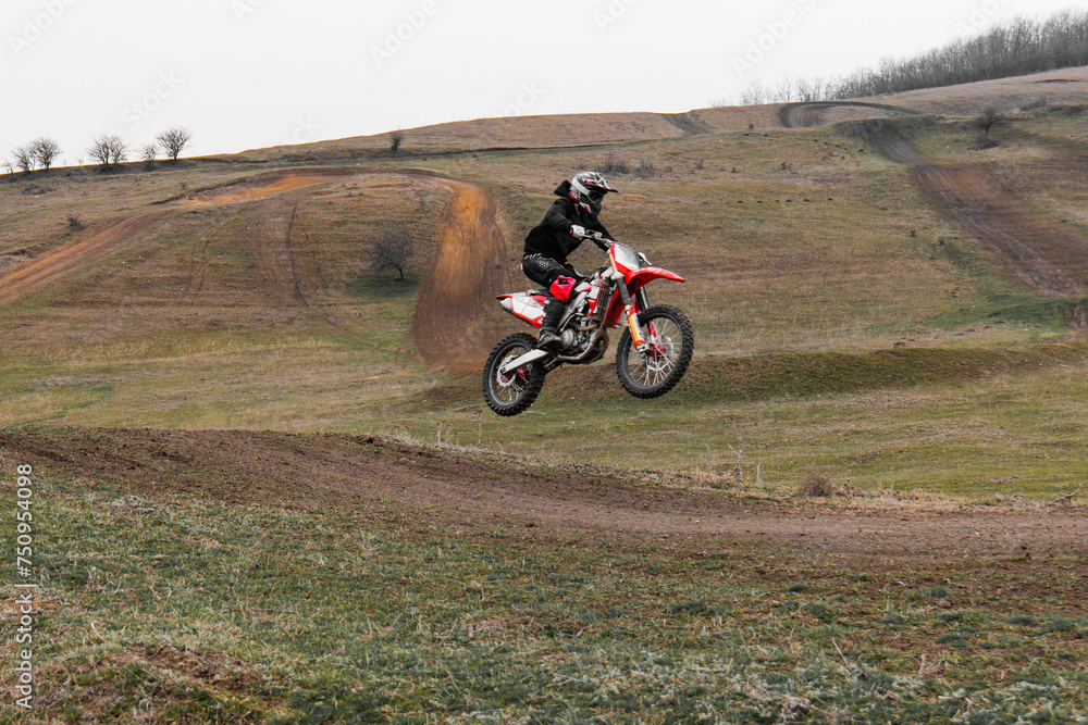 Riding a motorcycle with helmet on an offroad track