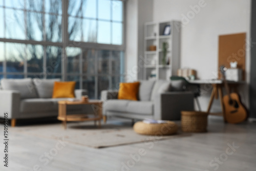 Stylish interior of modern living room with sofas  coffee table and pillows  blurred view