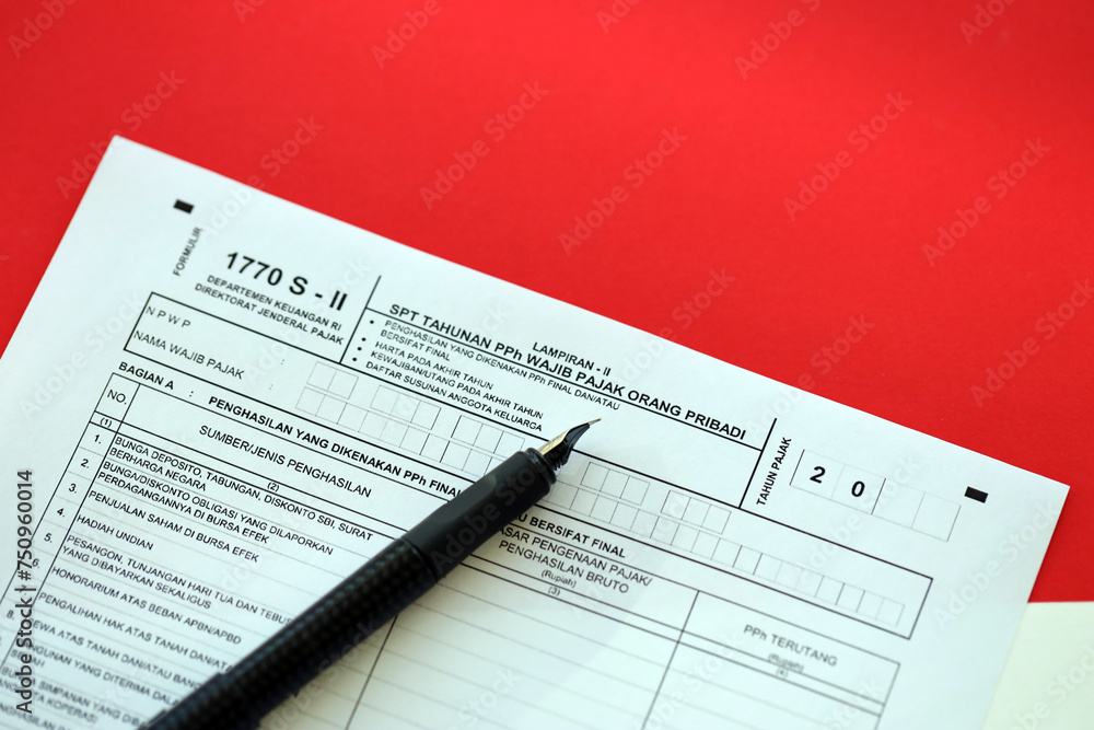 Indonesian tax form 1770 S - 2 Individual Income Tax Return and pen on table close up Indonesian tax form 1770 S - 2 Individual Income Tax Return and pen on table close up