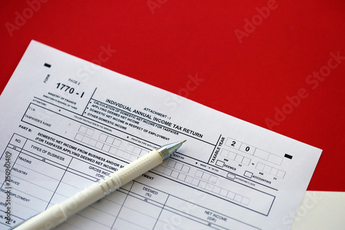 Indonesian tax form 1770-1 Individual Income Tax Return and pen on table close up photo