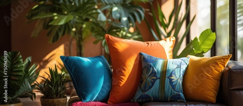A couch in a room flooded with sunlight is adorned with a variety of pillows, adding warmth and comfort to the space. The abundance of cushions enhances the ambiance, inviting relaxation and coziness.