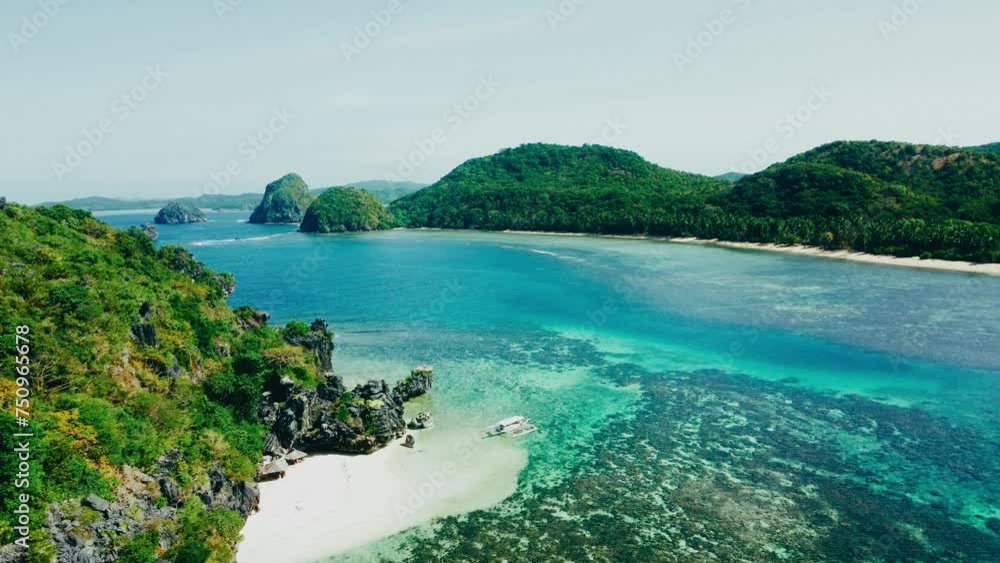 Aerial view 4k drone shot of small islands and beaches around Calauit National park Coron island, the Philippines. Crystal clear turquoise blue waters, palm tree lined white sandy beaches, and visible Aerial view 4k drone shot of small islands and beaches around Calauit National park Coron island, the Philippines. Crystal clear turquoise blue waters, palm tree lined white sandy beaches, and visible