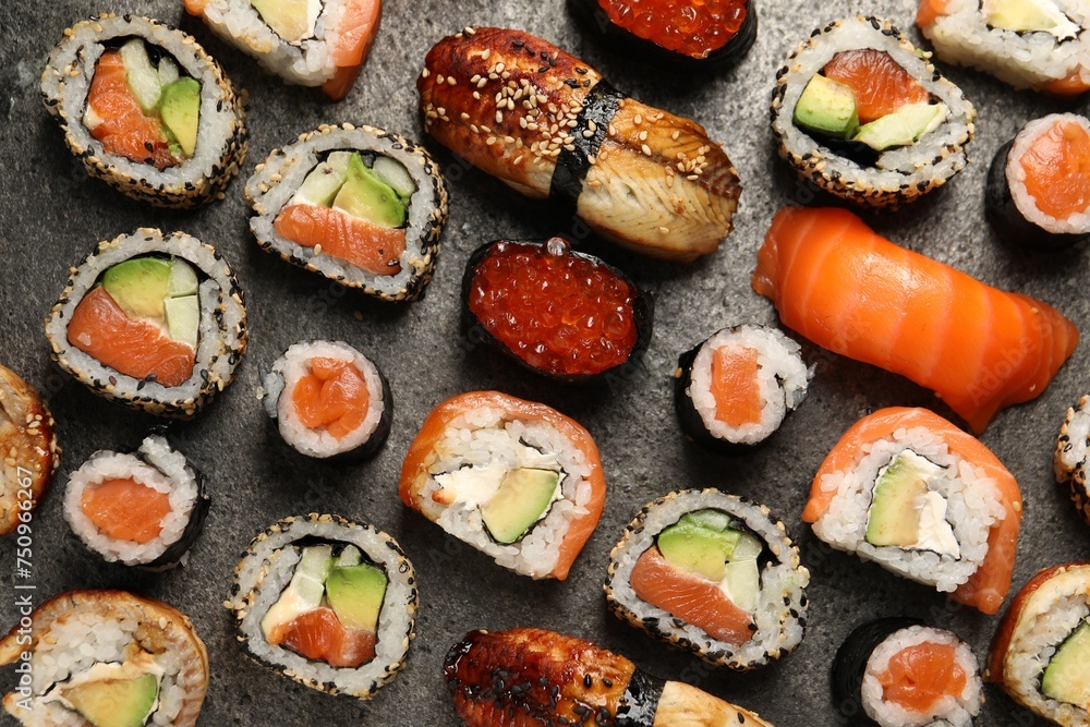 Different tasty sushi rolls on grey table, flat lay Different tasty sushi rolls on grey table, flat lay