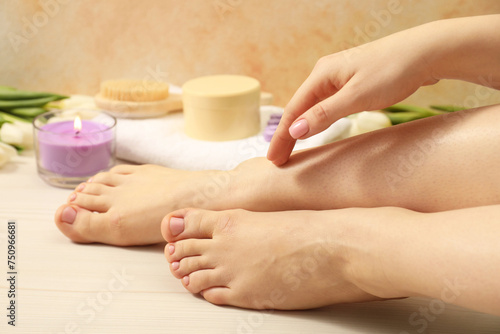 Woman with neat toenails after pedicure procedure on wooden floor, closeup