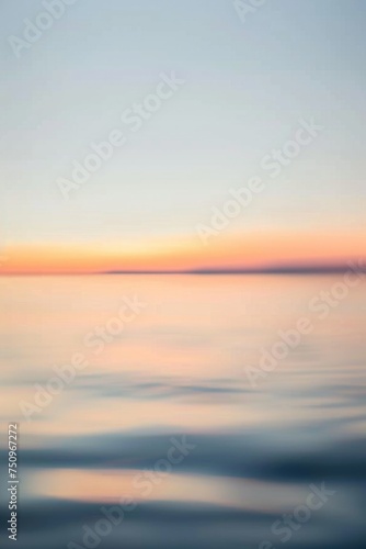 Blurry photo of the ocean at sunset. Ideal for backgrounds and relaxation concepts