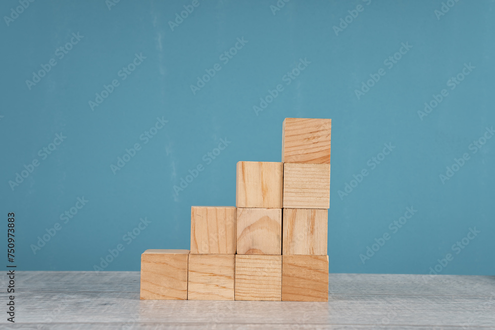 wooden block stacking as step stair on blue background. Business concept for growth success process. wooden block stacking as step stair on blue background. Business concept for growth success process.