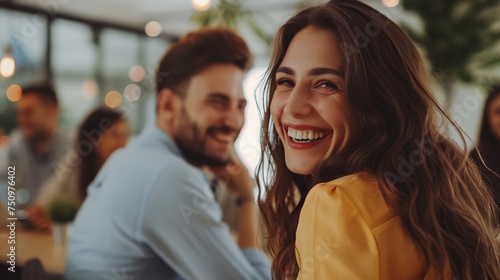 a woman smiling and sitting next to a man in a restaurant