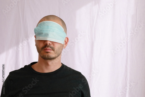 expressive average looking bald man wearing a medical mask