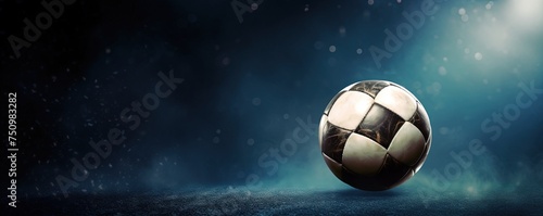 Football or Soccer with spotlight and fade-out shadow in the dark background. Copy space. Sport and game concept.