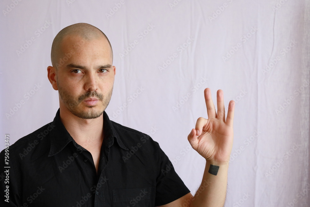 bald man in black shirt showing emotion and making gesture bald man in black shirt showing emotion and making gesture