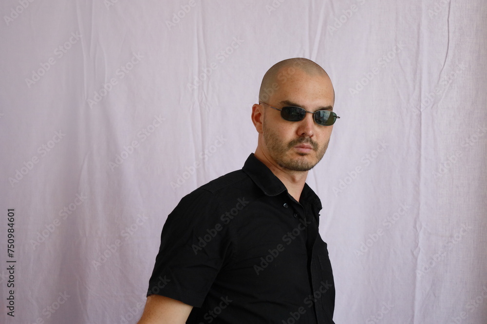 Fototapeta premium expressive bald man , mafia man , black shirt and sunglasses